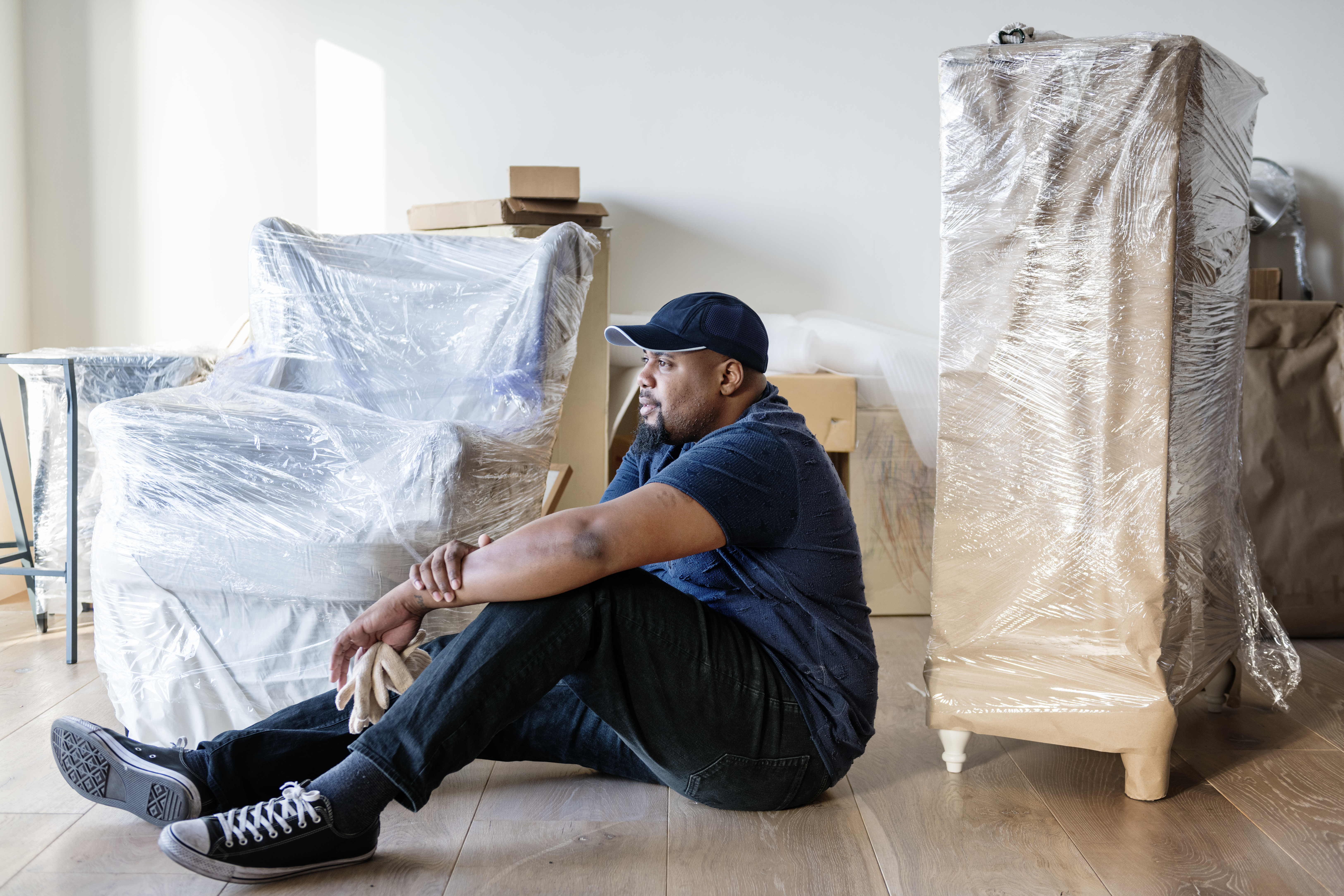 Black man moving furniture